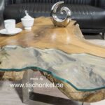 Couchtisch aus einem Baumstumpf Teak mit Glaseinleger und Tischgestell aus Edelstahl