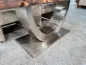 Preview: Metal base of a dining table with glass inlay on carpet.