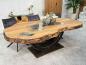 Preview: Massiver Holztisch aus recyceltem Holz mit Rohstahlgestell.