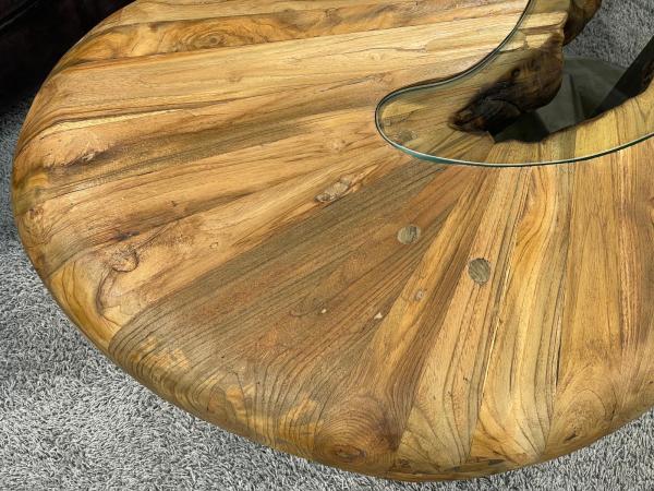 Round wooden coffee table with glass top and stainless steel frame.