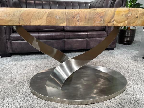 Living room table with stainless steel frame and wood top.