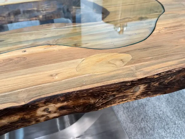 Solid wood dining table with glass inlays, close-up view.