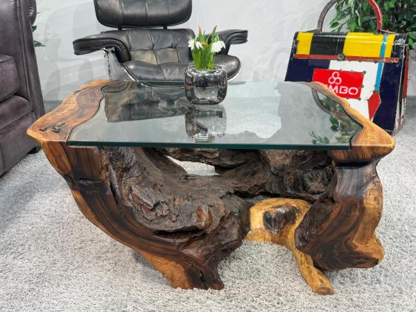 Round living room table made from Suar wood with glass detail.