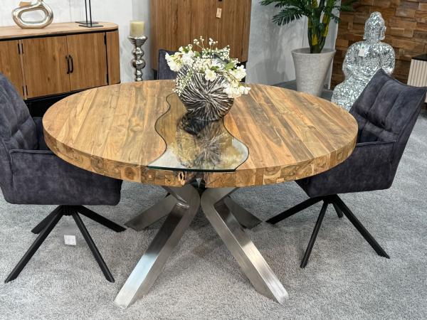 Round dining table made of recycled wood with stainless steel frame.