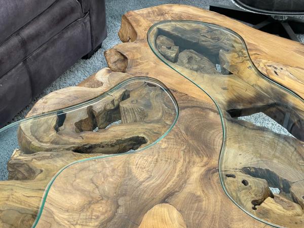 Coffee table with glass inlays and O-shaped steel legs.