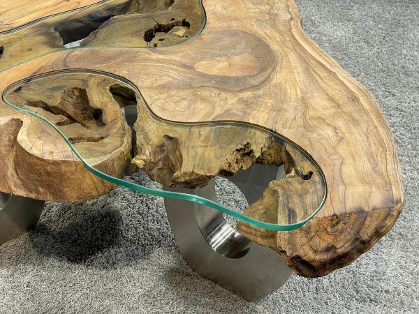 Wooden coffee table with glass inlay on carpeted floor.