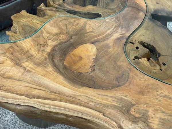 Coffee table with glass inlays and O-shaped steel legs.