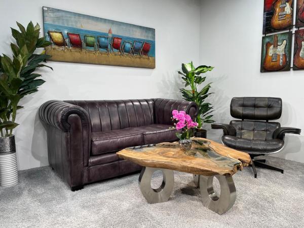 Coffee table with glass inlays and O-shaped steel legs.