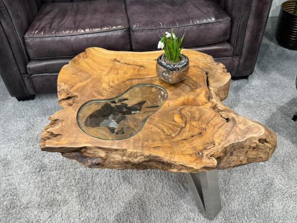 Log table with glass top, black legs, decoration on top