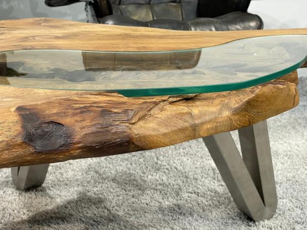 Log coffee table with glass top and metal legs.