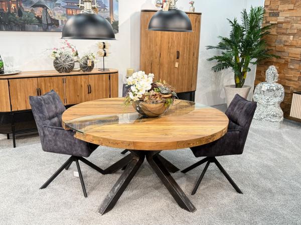 Round dining table made of recycled wood with glass and steel frame.
