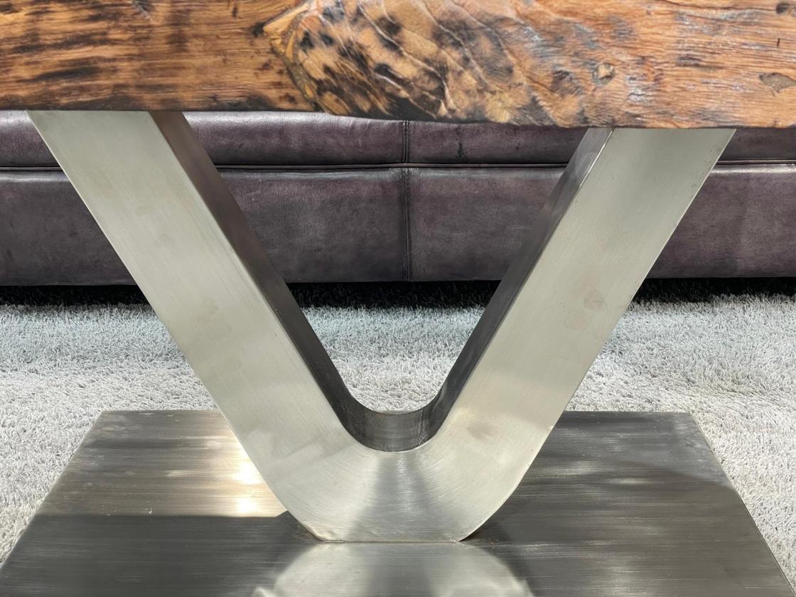Coffee table from antique rice mortar with V-shaped metal base