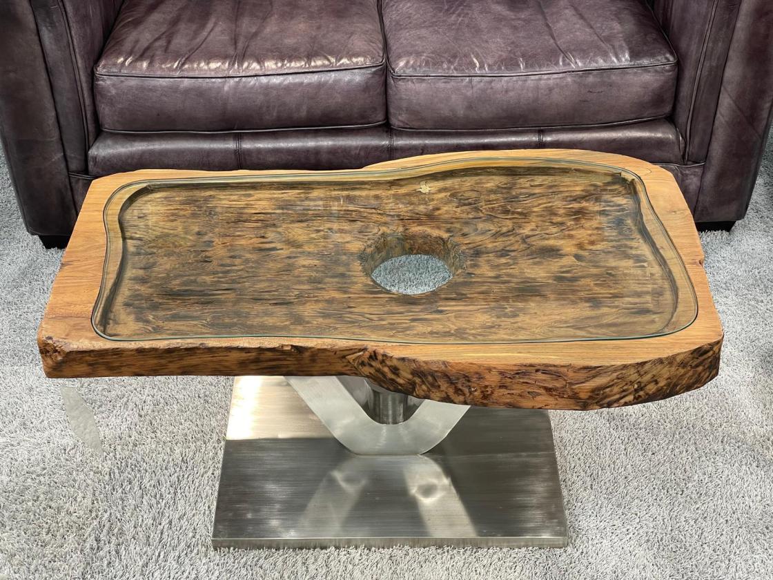 Coffee table from antique rice mortar, wood top, metal base.