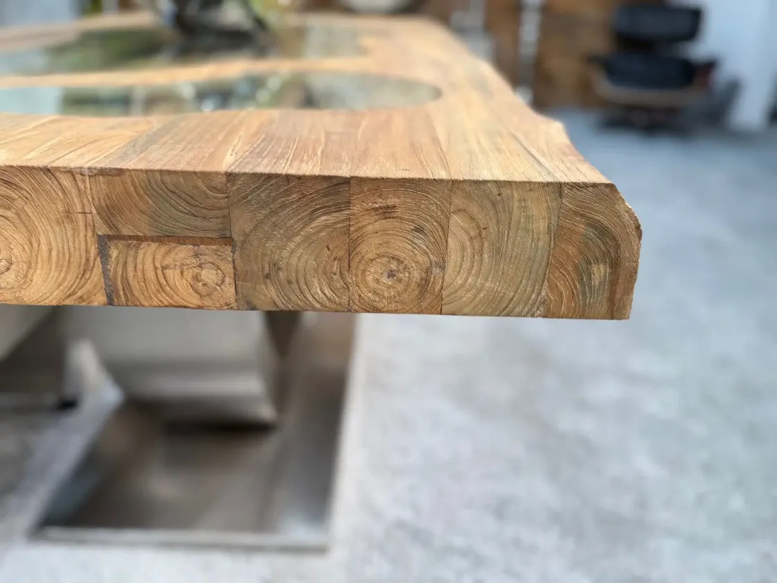 Close-up of a solid wood table with glass inlays.