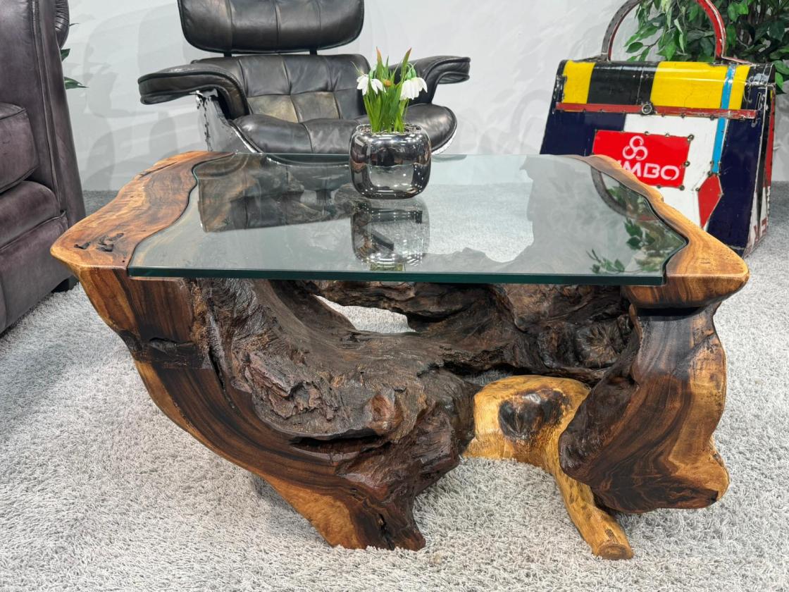 Round living room table made from Suar wood with glass detail.
