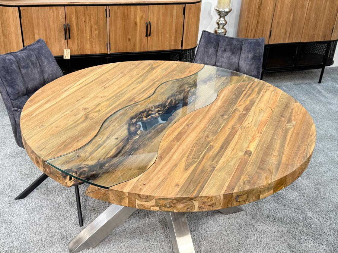 Round dining table made of recycled wood with stainless steel base and glass insert.