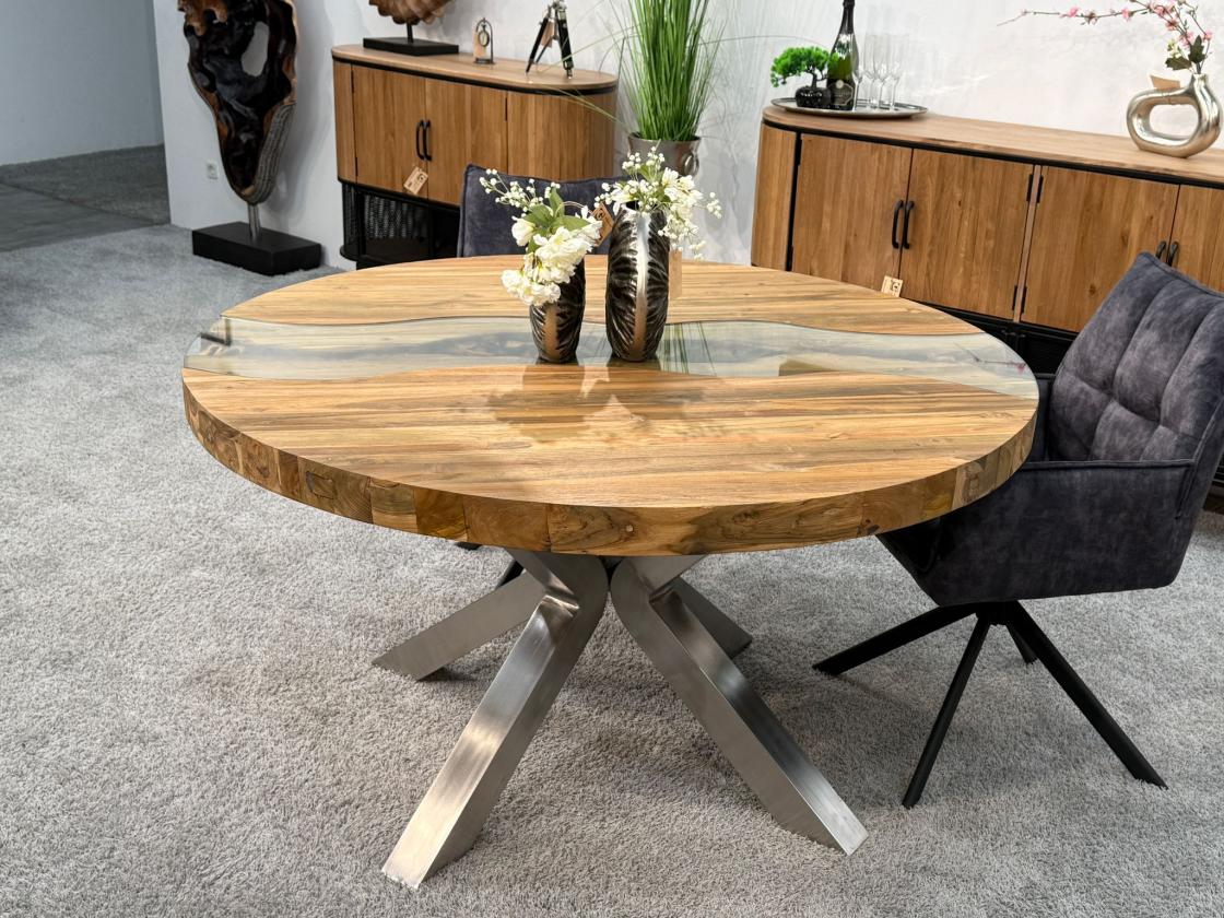 Round dining table made of recycled wood with stainless steel base.