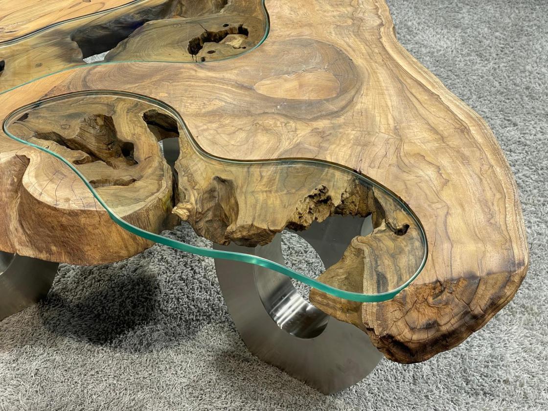 Wooden coffee table with glass inlay on carpeted floor.