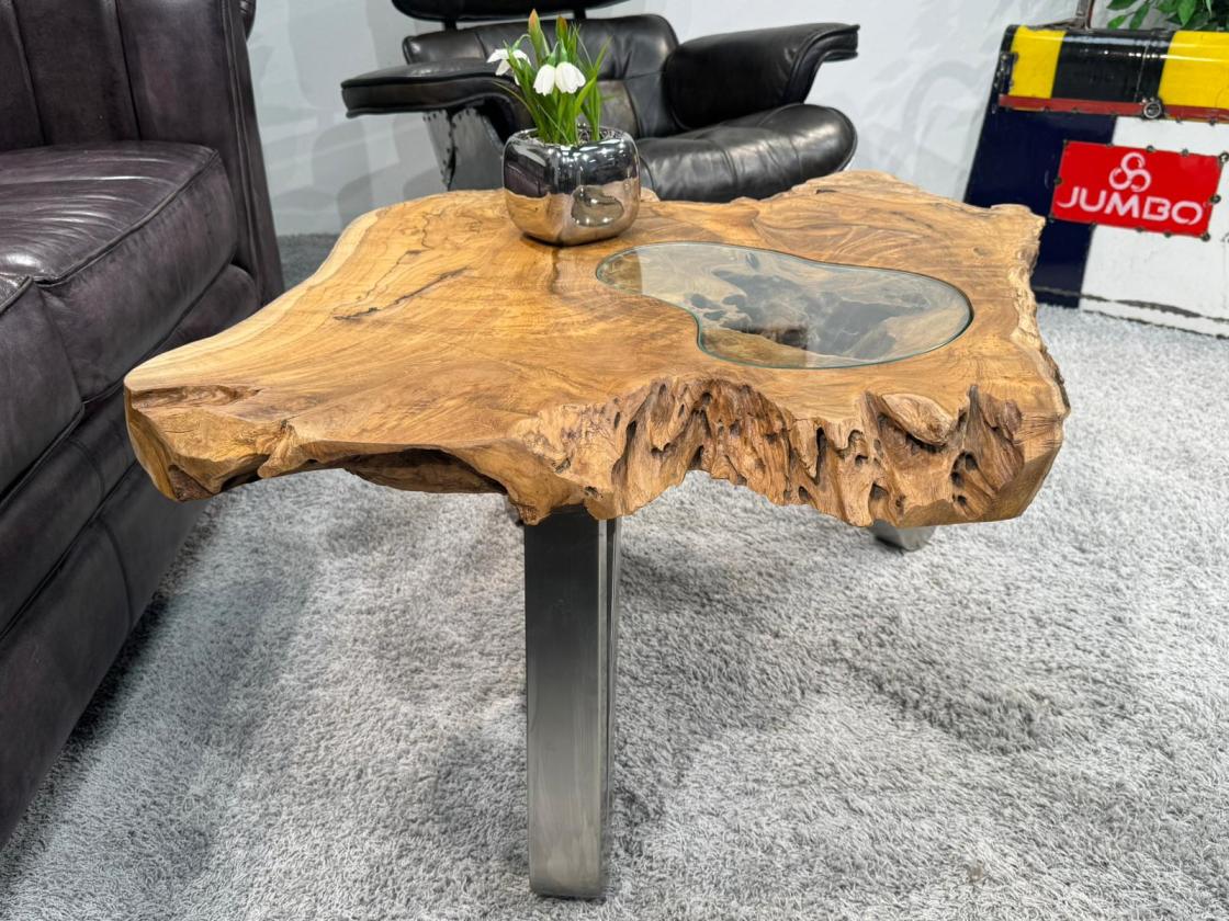 Round log table with glass top and decoration.