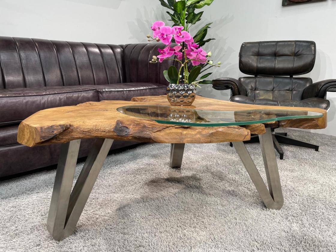 Log coffee table with glass top and metal legs.