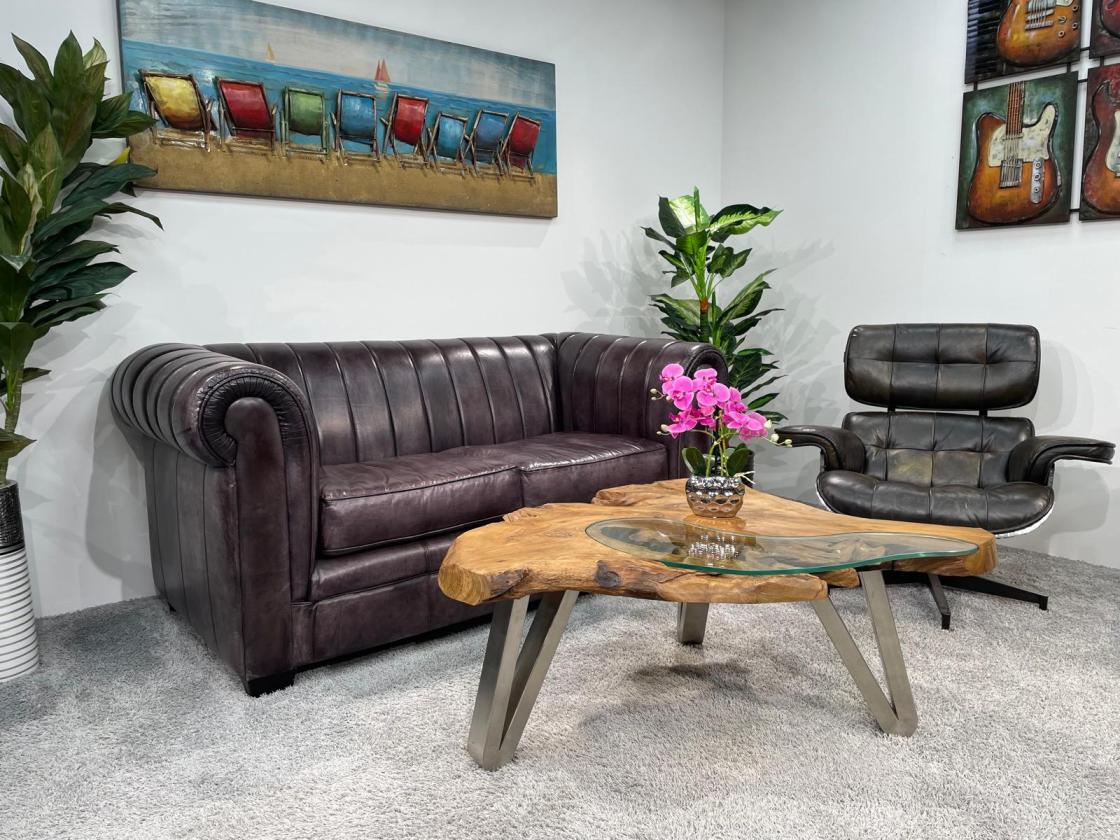 Log coffee table with metal legs in living room.