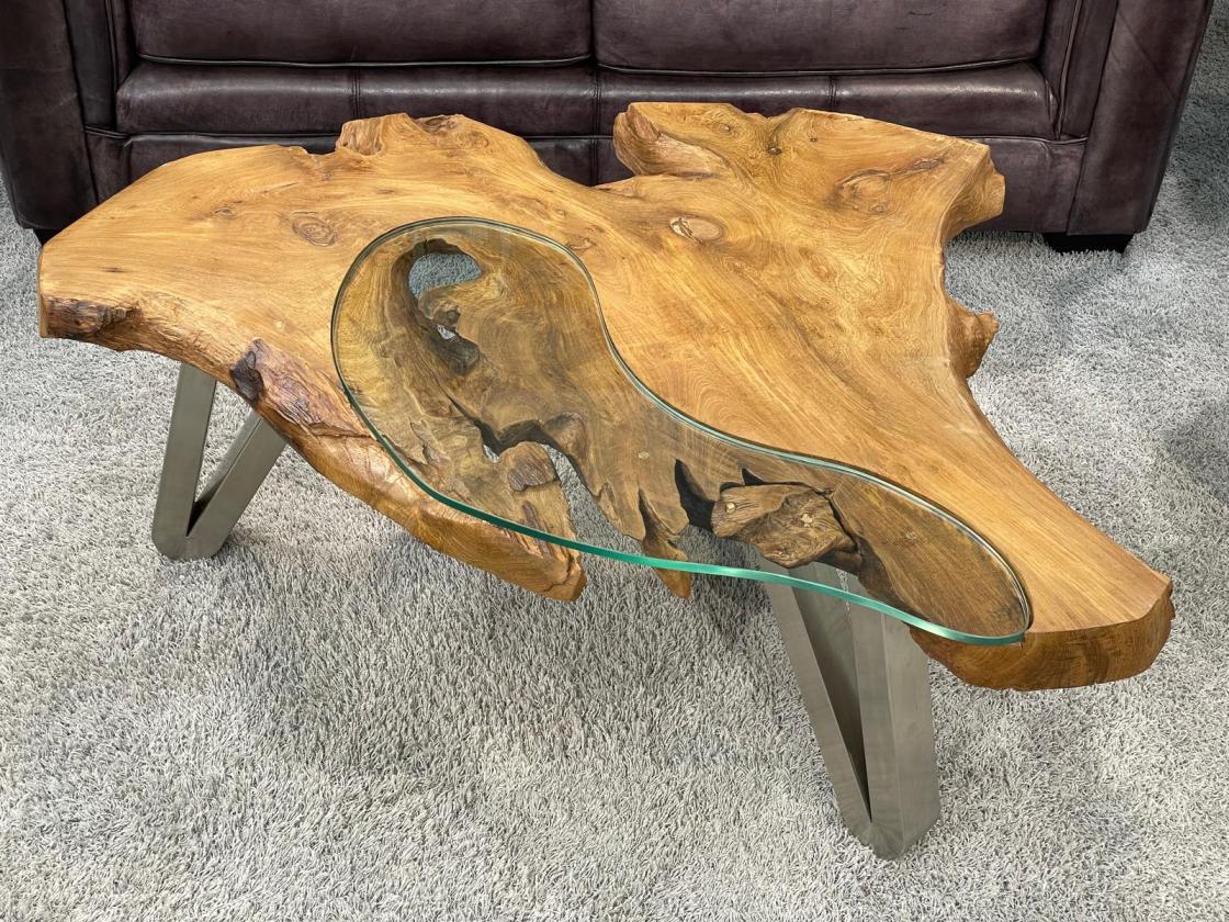 Log coffee table with glass top, irregular shape.