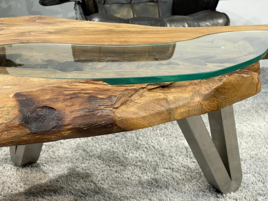 Log coffee table with glass top and metal legs.