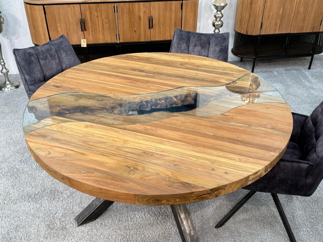 Round dining table made of recycled wood with glass and steel base.