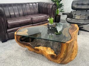 Wohnzimmertisch aus Suar-Baumstamm, 100x80x42 cm, mit Metallbeinen.